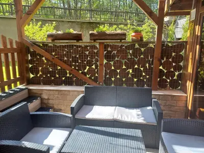 a patio with two chairs and a bench at Ковачева-3 in Bansko