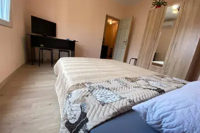 a bedroom with a bed and a television in it at Sunny apartment by the river in Sandanski