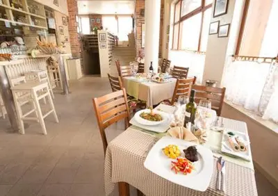 a dining room with tables and chairs with food on them at Pirin Golf Hotel Private Studios - Sani, Bansko in Razlog