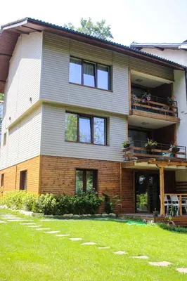 a large house with a lawn in front of it at Вила Край реката in Botevgrad