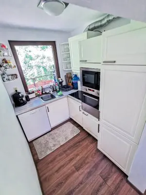 a kitchen with white cabinets and a white refrigerator at Вила Край реката in Botevgrad