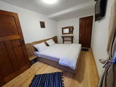 a bedroom with a bed and a television in it at Вила 111 in Sapareva Banya