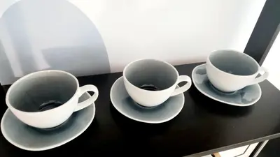 three cups and saucers sitting on a table at Студио Цвят/ Studio Colour in Blagoevgrad