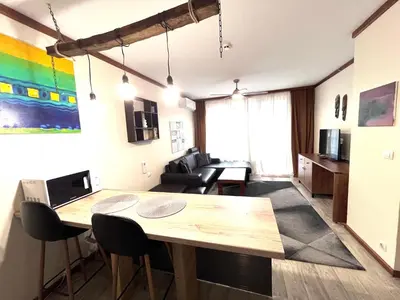 a living room with a table and a couch at Private Spa Luxury apartments in Bansko