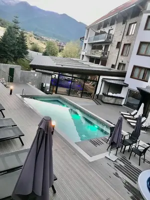 a swimming pool in front of a building at Private Spa Luxury apartments in Bansko