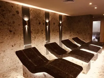 a row of chairs in a room with lights at Private Spa Luxury apartments in Bansko