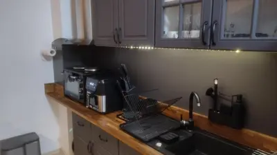 a kitchen counter with a sink and a microwave at Pearl XL in Pamporovo