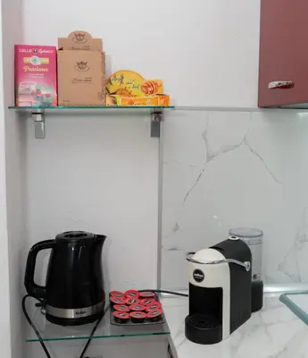 a coffee maker and a toaster sitting on a counter at Къща за гости Шарон in Petrich
