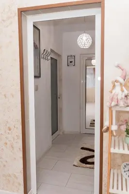 a hallway with a door leading into a room at Къща за гости Шарон in Petrich