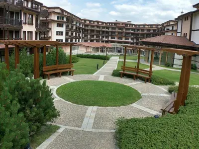 a park with benches and a circle of grass at Bardarova Apartments Downtown Bansko in Bansko