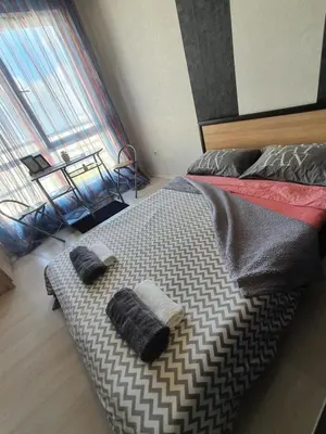 a bed with two pillows on it in a bedroom at Nights apartment in Sofia