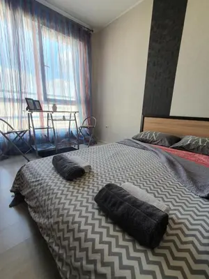 a bedroom with a large bed with two pillows on it at Nights apartment in Sofia