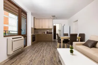 a living room and kitchen with a couch and a table at 1BD Flat with a lovely terrace in the centre of Plovdiv by Flat Mаnager in Plovdiv