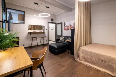 a hotel room with a bed and a dining room at Bohemia - New Apartment with Stylish Design in Sofia