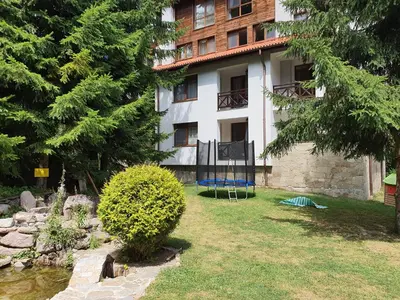 a building with a yard in front of it at Апартамент Лейк Вю, вила Флора, комплекс Маунтин лейк in Smolyan