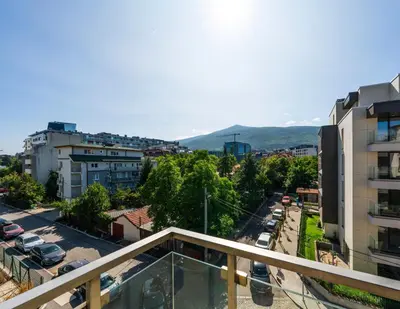 a view of a city from a balcony of a building at Vertigo Modern 2-Bedroom Apartment with Parking & Vitosha View in Sofia