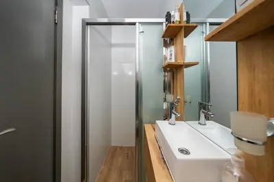 a bathroom with a shower and a sink at Vertigo Modern 2-Bedroom Apartment with Parking & Vitosha View in Sofia