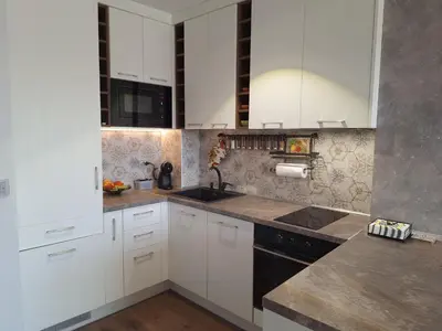 a kitchen with white cabinets and a black sink at Cloud 6 -Top Center,360° view,Free private parking in Plovdiv