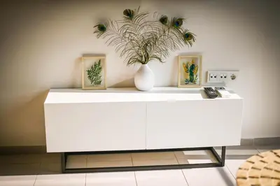 a white cabinet with a vase with a plant on it at Cloud 6 -Top Center,360° view,Free private parking in Plovdiv