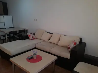 a living room with a couch and a table at Старият Хан-Б24 in Bansko