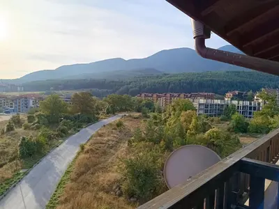 a balcony with a view of a road and mountains at Старият Хан-Б24 in Bansko