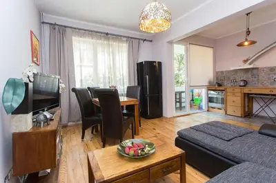 a living room with a couch and a table at Colorful 2BDR Apartment in the City Center in Sofia