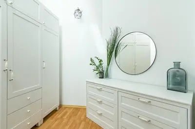a bedroom with a white dresser and a mirror at Todorka Apartments in Bansko in Bansko