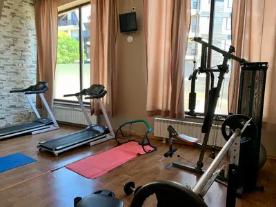 a gym with treadmills and exercise bikes in a room at Luxury Apartment Pirin Chalet in Terra Complex in Bansko