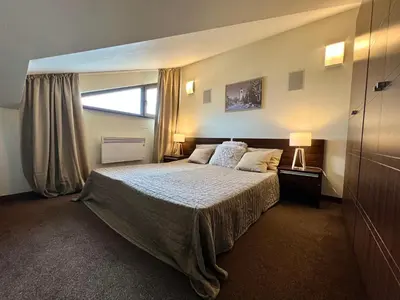 a bedroom with a bed and a large window at Luxury Apartment Pirin Chalet in Terra Complex in Bansko