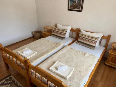 two twin beds with pillows on them in a room at Къща за гости Иглика in Trigrad