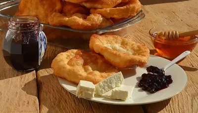a plate of food with pastries and jam on a table at Къща за гости Иглика in Trigrad
