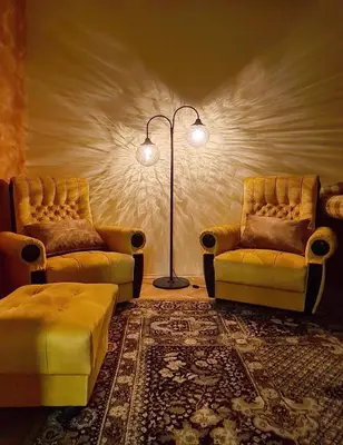 a living room with two chairs and a floor lamp at Panoramic and Spacious Flat near the City Centre in Sofia