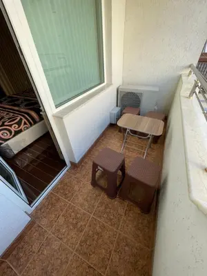 a small room with a table and two stools at Apart 47 in Smolyan