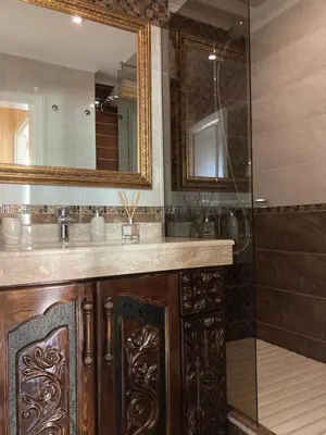 a bathroom with a wooden sink and a shower at Apart 47 in Smolyan