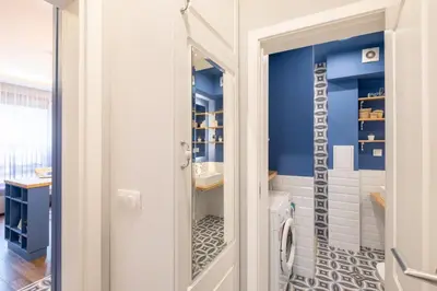 a bathroom with blue walls and a toilet and a sink at Designer & Cozy 2BD Flat with a parking in the city center by Flat Mаnager in Sofia