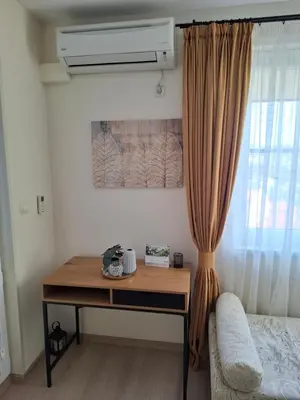 a desk in a room with a bed and a window at The View in Sandanski