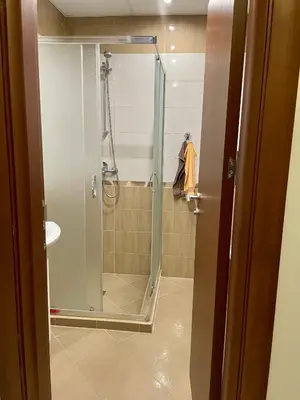 a shower with a glass door in a bathroom at The View in Sandanski