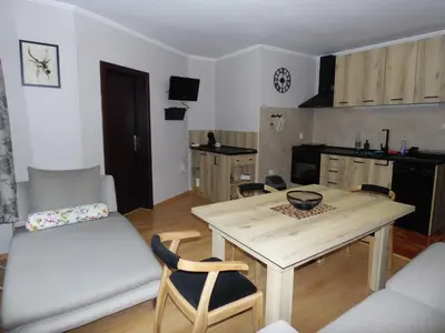 a kitchen and dining room with a table and chairs at Deer's Home at Elit Pamporovo in Pamporovo