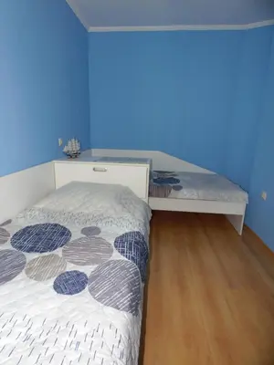 a bedroom with a bed and a blue wall at Deer's Home at Elit Pamporovo in Pamporovo
