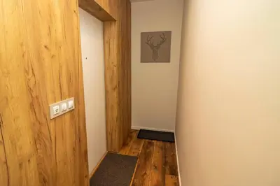 a hallway with a wooden door and an empty room at Exclusive Top Central Studio in Sofia