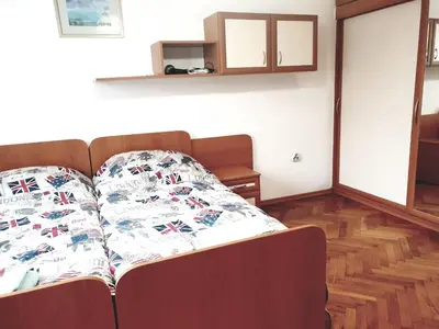 a bed with a blanket on it in a room at Jasmine appart Metro station, 2BDR, FREE Parking in Sofia