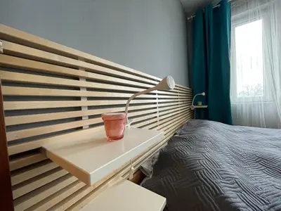 a bedroom with a bed and a desk with a lamp at Lovely 2-bedroom serviced apartment with SPA in Bansko