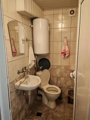 a small bathroom with a toilet and a sink at Дом Бакалски-Кмета in Narechenski Bani