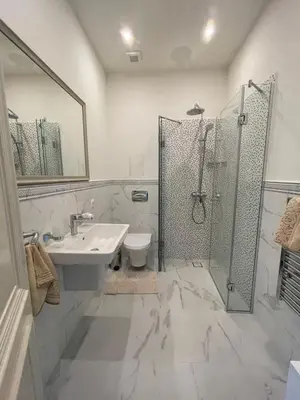 a white bathroom with a sink and a shower at FELIX KANITZ Apartments - in the heart of Kapana district in Plovdiv