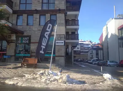 a sign in the snow in front of a building at Илен 433 Bansko Royal Towers in Bansko