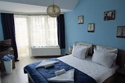 a bedroom with a large bed with blue walls at New & Comfortable home in Blagoevgrad center in Blagoevgrad