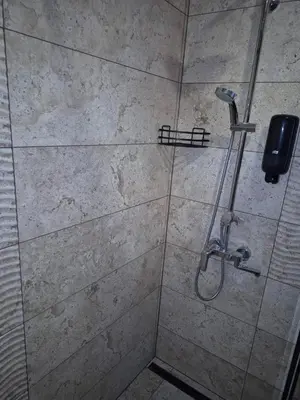 a bathroom with a shower with a phone on the wall at Monteverde Ski Lift Apartment Bansko in Bansko