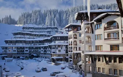 a group of buildings with snow on the ground at Ski-in ski-out Studio 2A7 Grand Monastery in Pamporovo