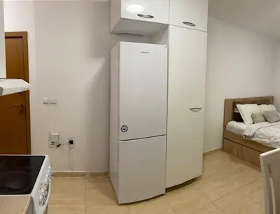 a white refrigerator in a kitchen with a bed at Ski-in ski-out Studio 2A7 Grand Monastery in Pamporovo