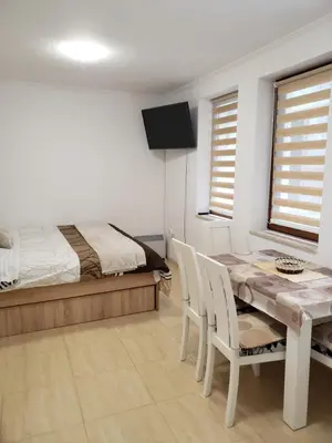 a bedroom with a bed and a table and chairs at Ski-in ski-out Studio 2A7 Grand Monastery in Pamporovo